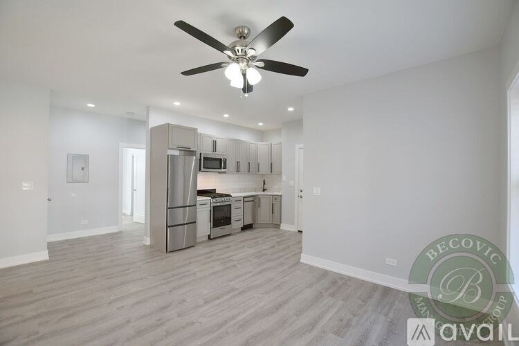 A modern kitchen with a refrigerator, microwave, and oven.