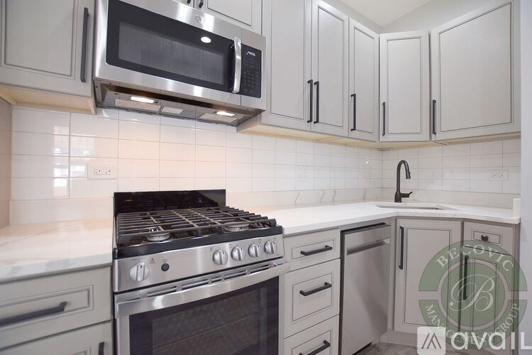 A kitchen with a stove top oven and microwave above it.