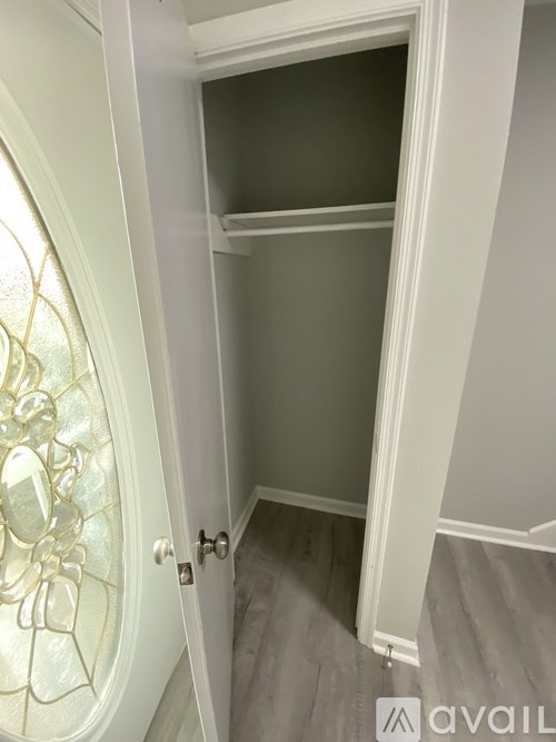 A white door with a glass window and a white frame.