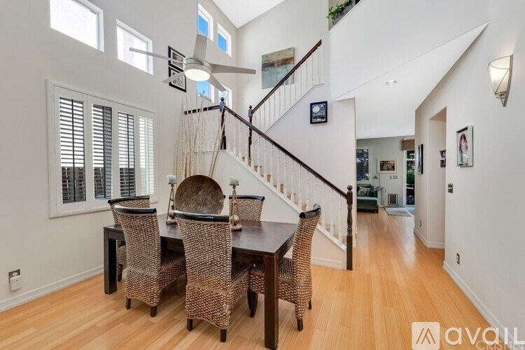 A dining room with a wooden table and chairs is available for rent.