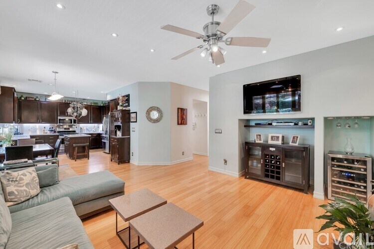 A living room with a couch, coffee table, and a television.