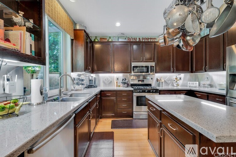 A kitchen with brown cabinets and a white countertop.