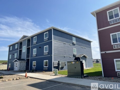 A blue and grey building with a red building next to it.