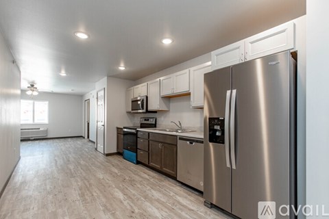 A modern kitchen with stainless steel appliances and wooden cabinets.