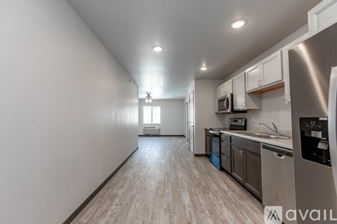 A kitchen with a refrigerator on the right side.