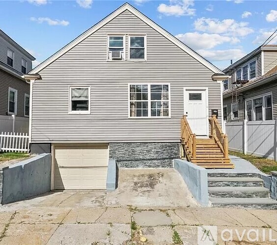 A two-story house with a garage and a front porch.