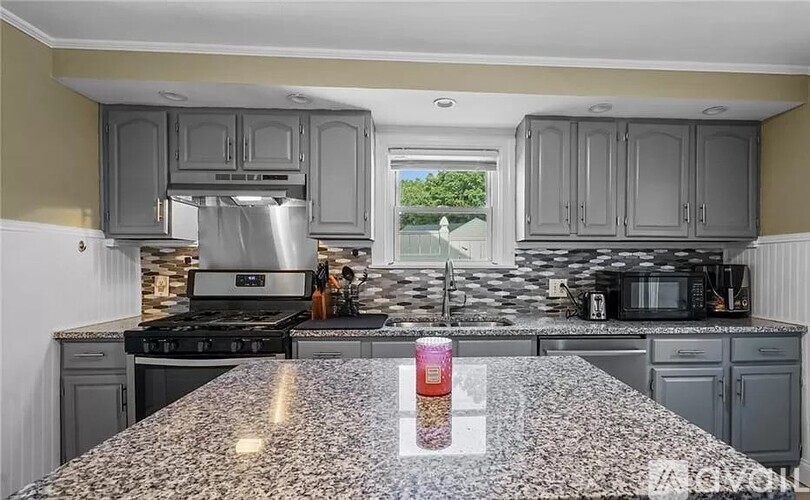 A kitchen with granite countertops and stainless steel appliances.