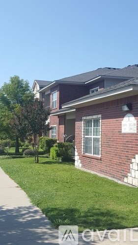 A house with a red brick exterior and a white window.