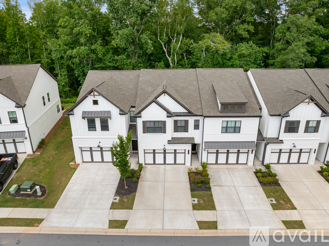 A modern two-story house with a garage is available for sale.