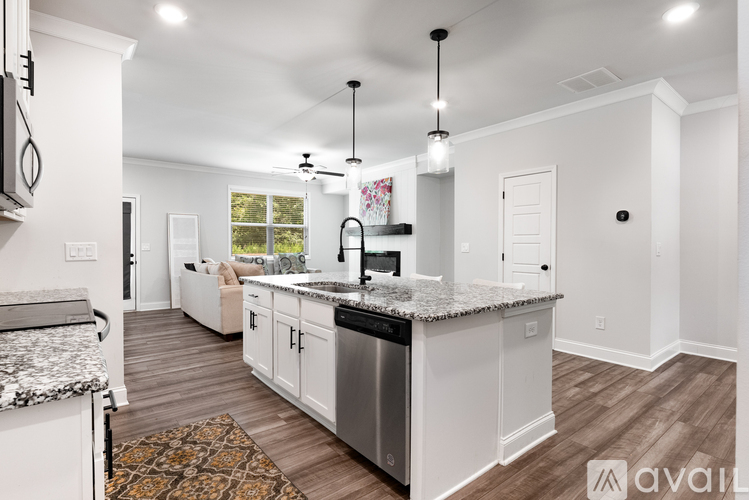 A modern kitchen with a refrigerator, microwave, and stove top oven.