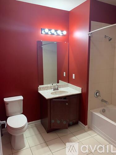 A bathroom with red walls and a white toilet.