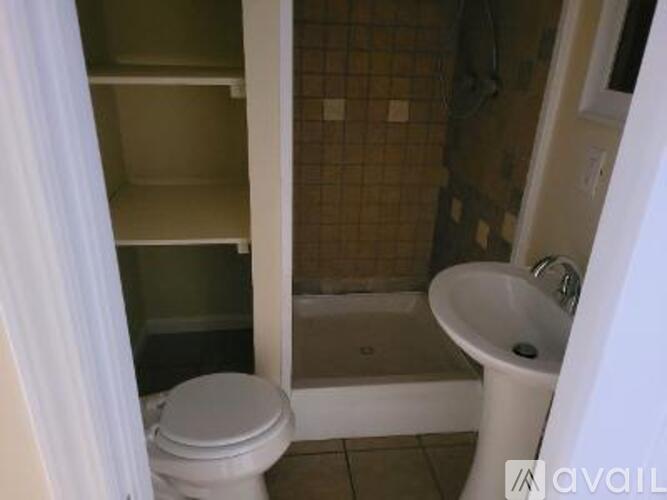 A bathroom with a toilet, sink, and bathtub.
