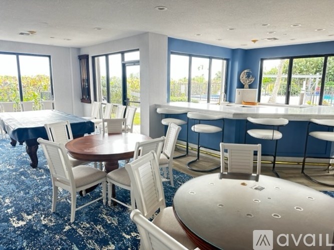 A dining area with a round table and chairs.