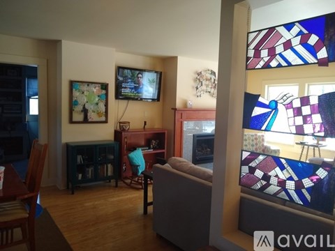A living room with a television and a couch.