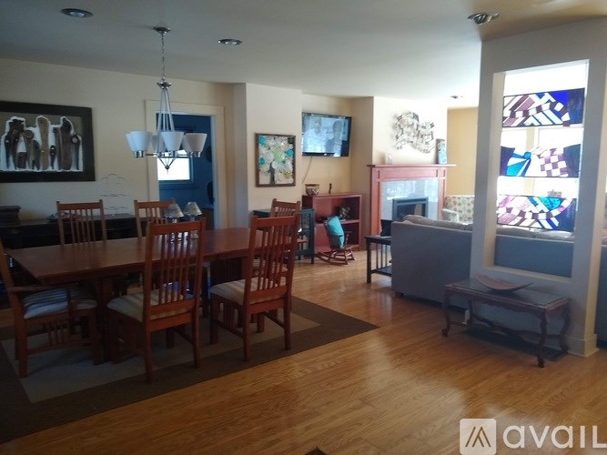 A living room with a dining table and chairs.