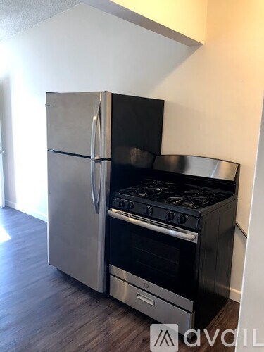 A stainless steel refrigerator and oven in a kitchen.