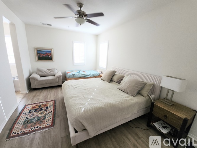 A living room with a large abstract painting on the wall.