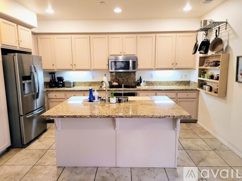 A kitchen with brown cabinets and a granite countertop.