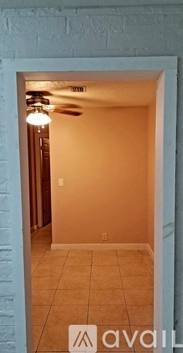 A room with a tiled floor and a ceiling fan.