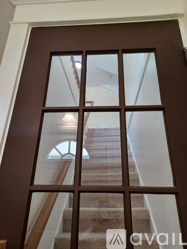 A brown door with a glass window in the middle.