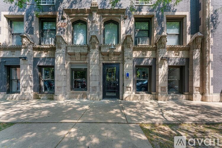 A building with a large front entrance and multiple windows.