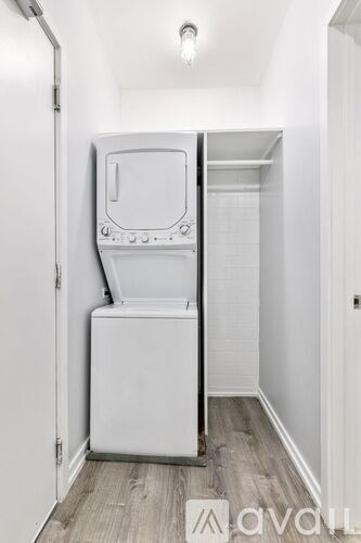 A white washing machine is in a small room.