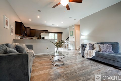 A modern living room with a grey couch and a wooden floor.