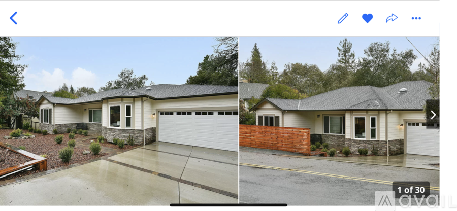 A two-story house with a garage and a driveway.