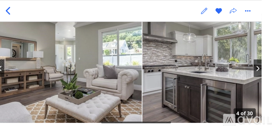 A modern kitchen with a white and brown color scheme.