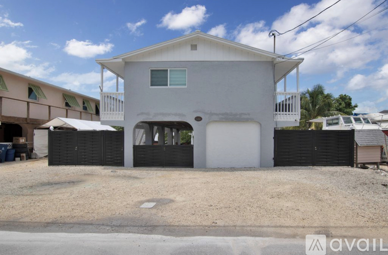 A two-story house with a garage is for sale.