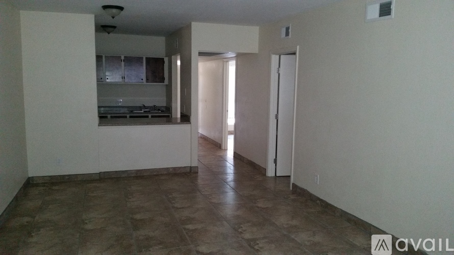 A room with a kitchen area and a living room area.