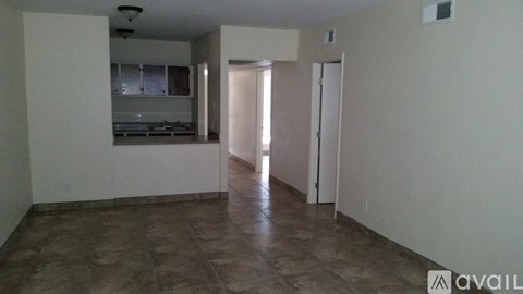 A room with a kitchen area and a living room area.