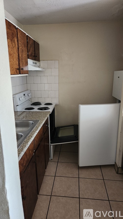 A kitchen with a white fridge, white stove and white oven.