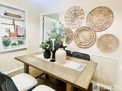 A dining room with a wooden table and chairs.