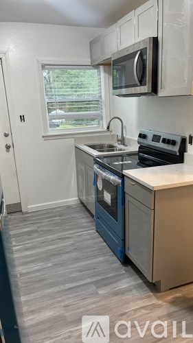 A kitchen with a stove, oven, and microwave.