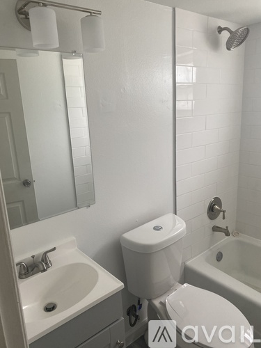 A white toilet sits next to a sink in a bathroom.