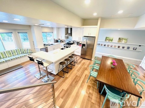 A kitchen with a table and chairs in the middle of the room.