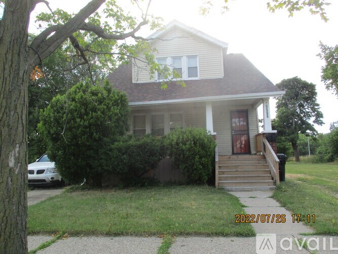 A house with a tree in front of it.