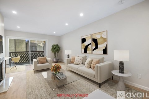 A living room with a couch, coffee table, and a painting on the wall.