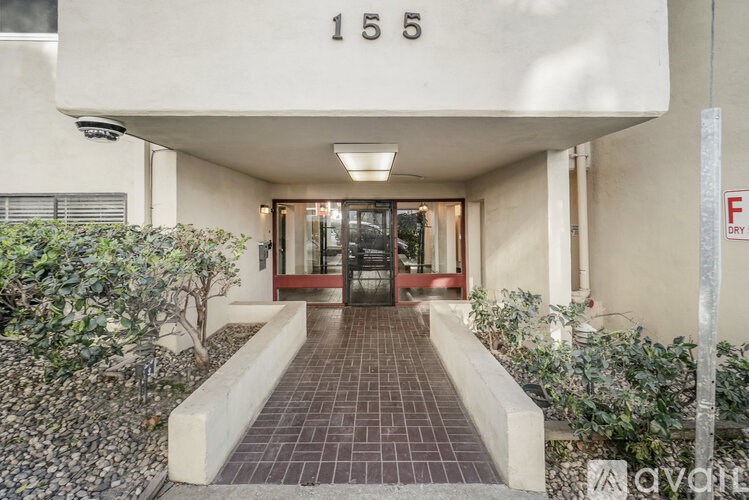 The image shows a building entrance with the number 155 on the wall.