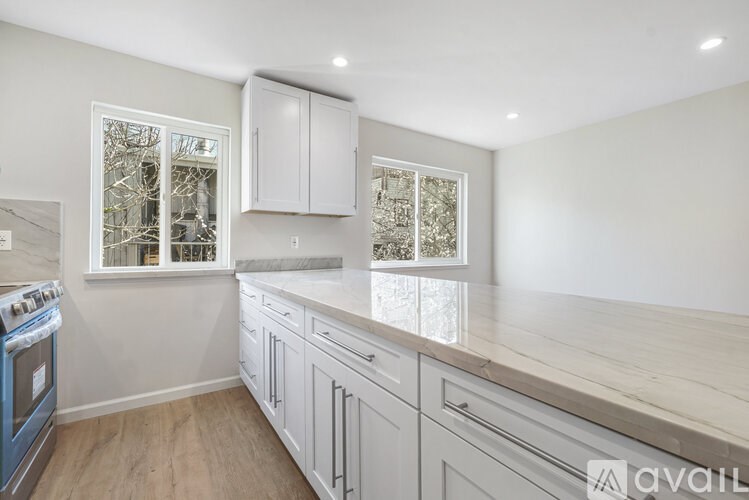 A kitchen with white cabinets and a blue oven.