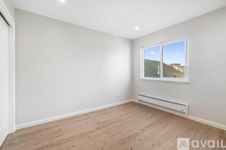 A room with a window and a radiator on the wall.
