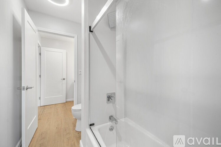 A white bathroom with a toilet and a bathtub.