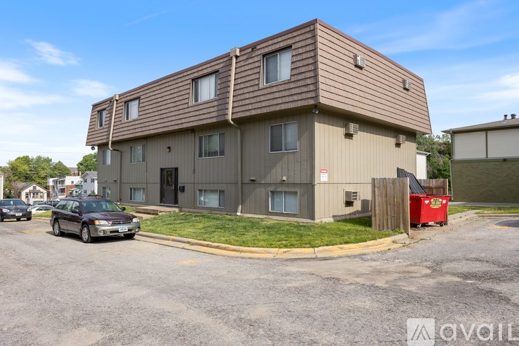 A building with a brown roof and a car parked in front.