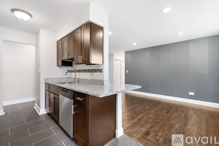 A kitchen with brown cabinets and a granite countertop.