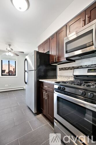 A kitchen with a black refrigerator, stove, and oven.