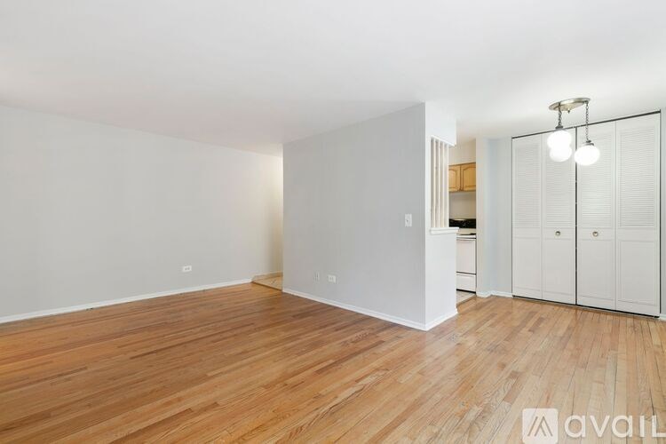 A room with wooden flooring and white walls.