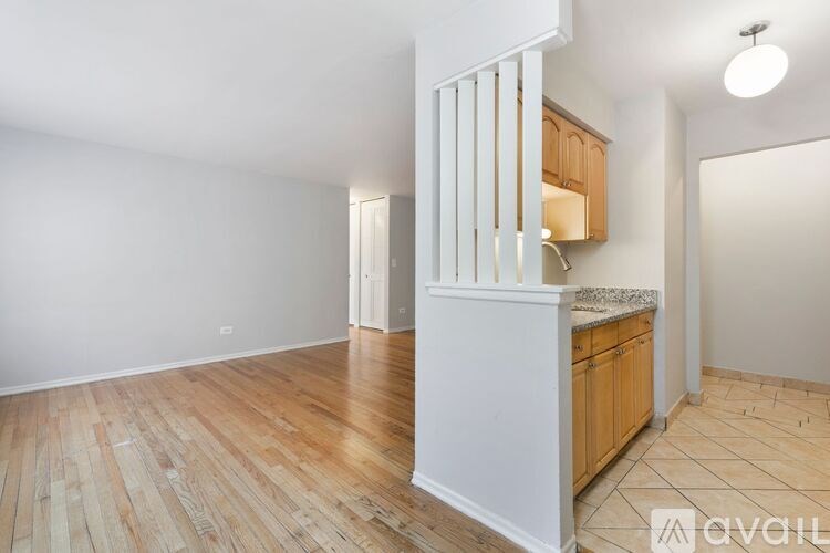 A room with wooden floors and a white staircase.