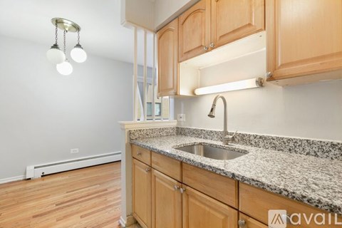 A kitchen with wooden cabinets and granite countertops.