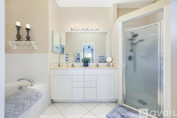 A bathroom with a white tub and sink.